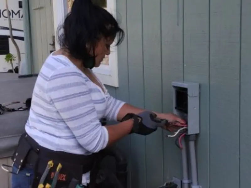 Licensed electrician wiring an exterior subpanel in Jasper